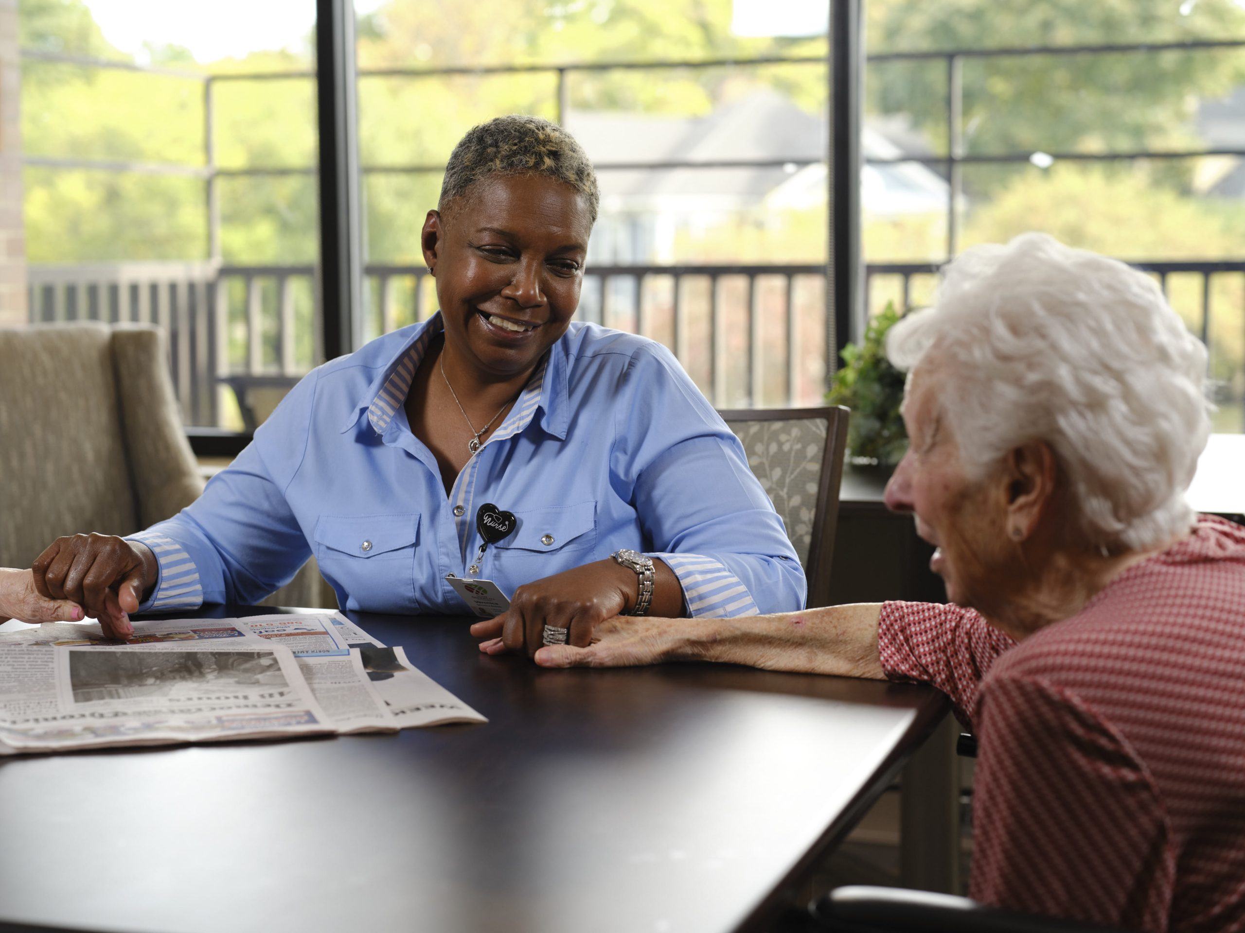 a skilled nursing care-giver helping an elderly woman