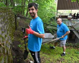 two volunteers smiling at the camera